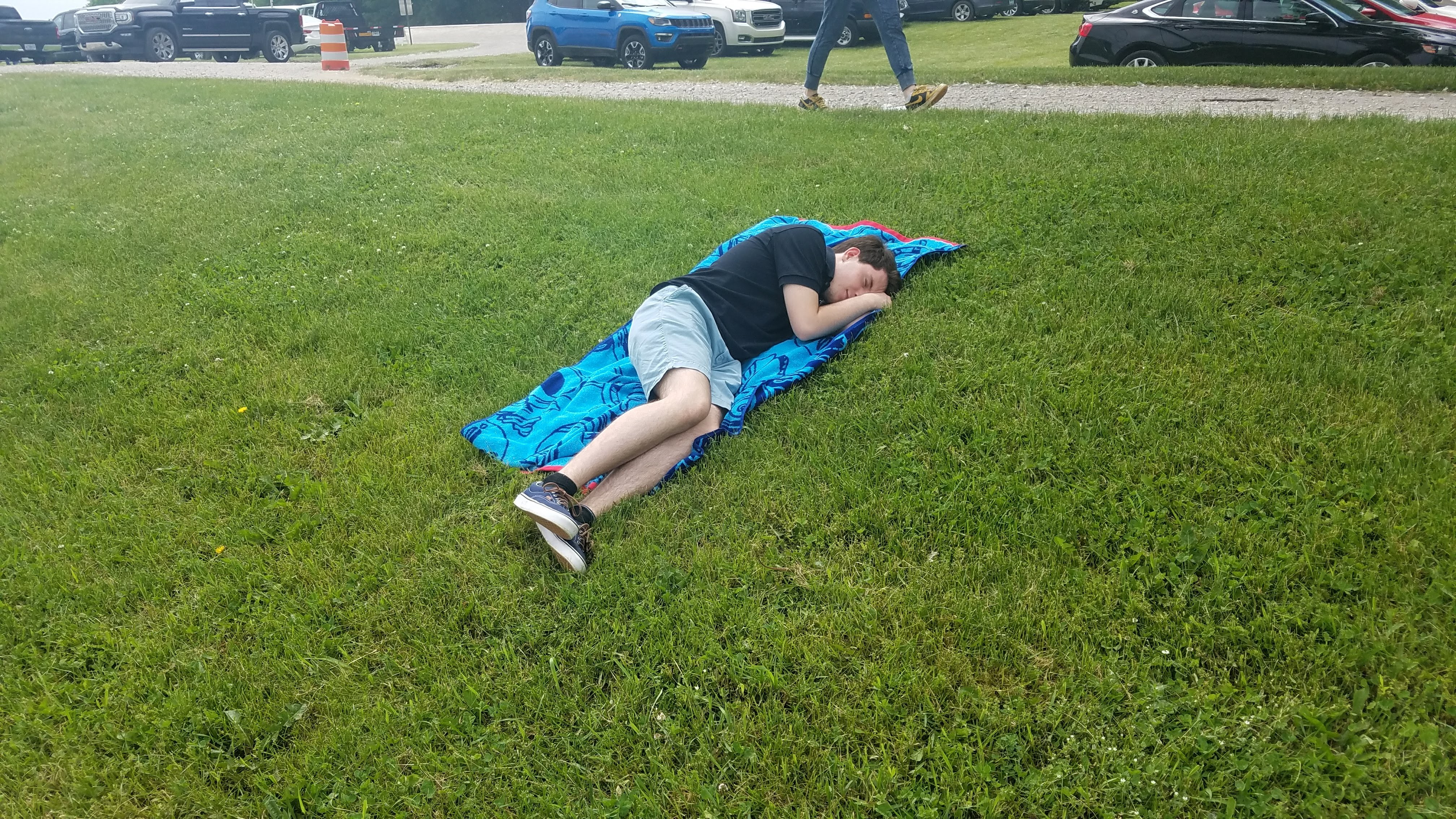 Tomas sleeping on the grass
